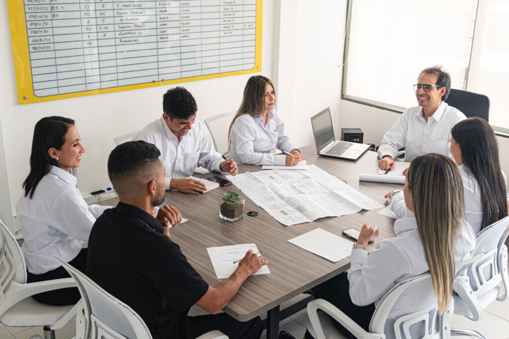 Pymes en Monterrey, hay un equipo de trabajadores platicando en una mesa